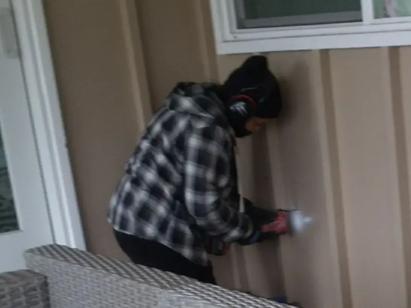Professional electrician installing an exterior outlet in Kenton